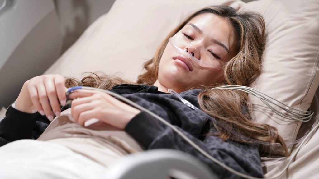 Luna (Lisa Yamada) is asleep in a hospital bed in The Bold and the Beautiful. Photo: CBS