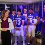 Nikki DeLoach and Warren Christie and a bunch of football players in Home Turf. Photo: Hallmark Channel