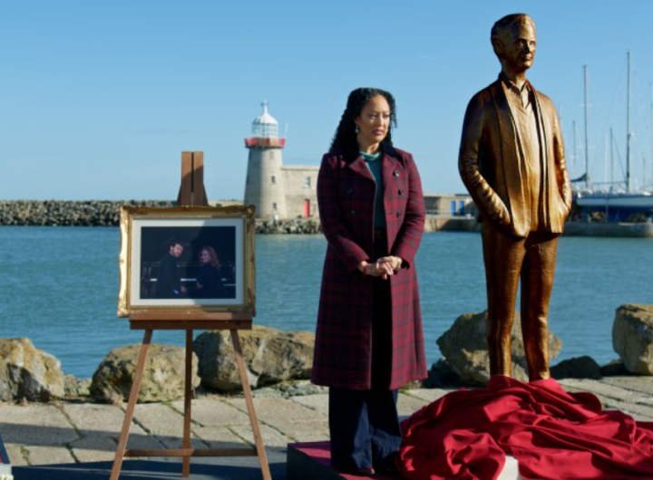 Tamera Mowry-Housley as Gethsemane standing near a memorial on a dock in Haunted Harmony Mysteries: Buried at C