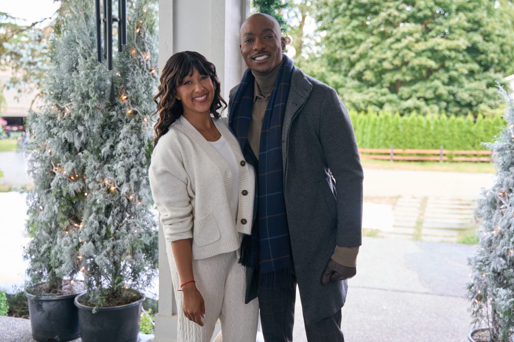 News anchor, Adam, is challenged by superfan, Robbie, to report good news at Christmas. Adam reluctantly takes him under his wing and finds a connection with Robbie’s mom. Photo: Tamera Mowry-Housley, B. J. Britt Credit: ©2025 Hallmark Media/Photographer: Syd Wong