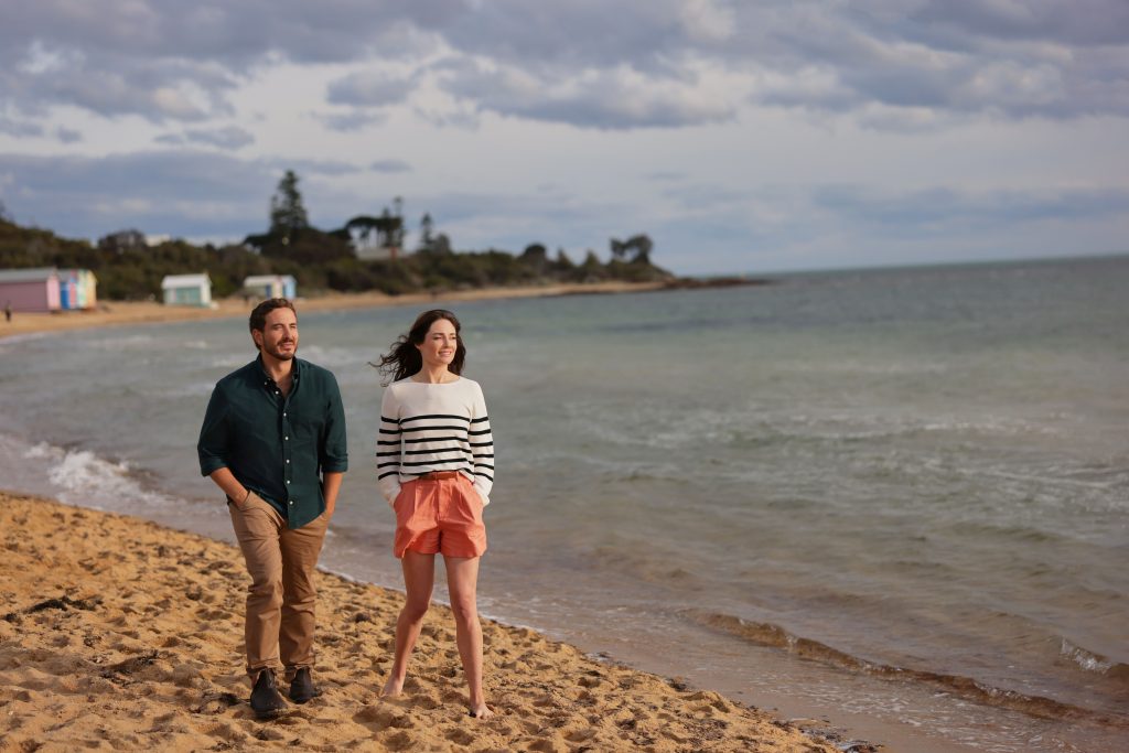 Ryan Corr and Mallory Jansen walking on a beach in A Melbourne Match from Hallmark Channel. Photo: Hallmark Media