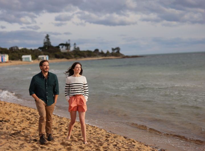 Ryan Corr and Mallory Jansen walking on a beach in A Melbourne Match from Hallmark Channel. Photo: Hallmark Media