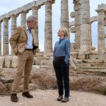 Hugh Laurie and Amy Poehler standing at the base of a Greek temple in Dig. Photo: Peacock